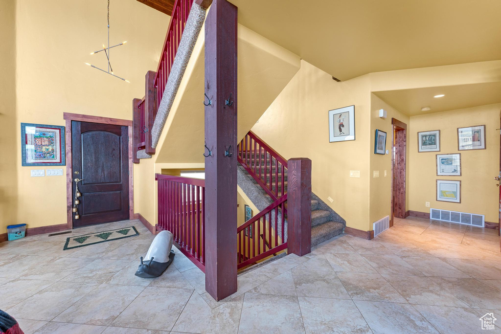 Entryway featuring tile floors and a high ceiling