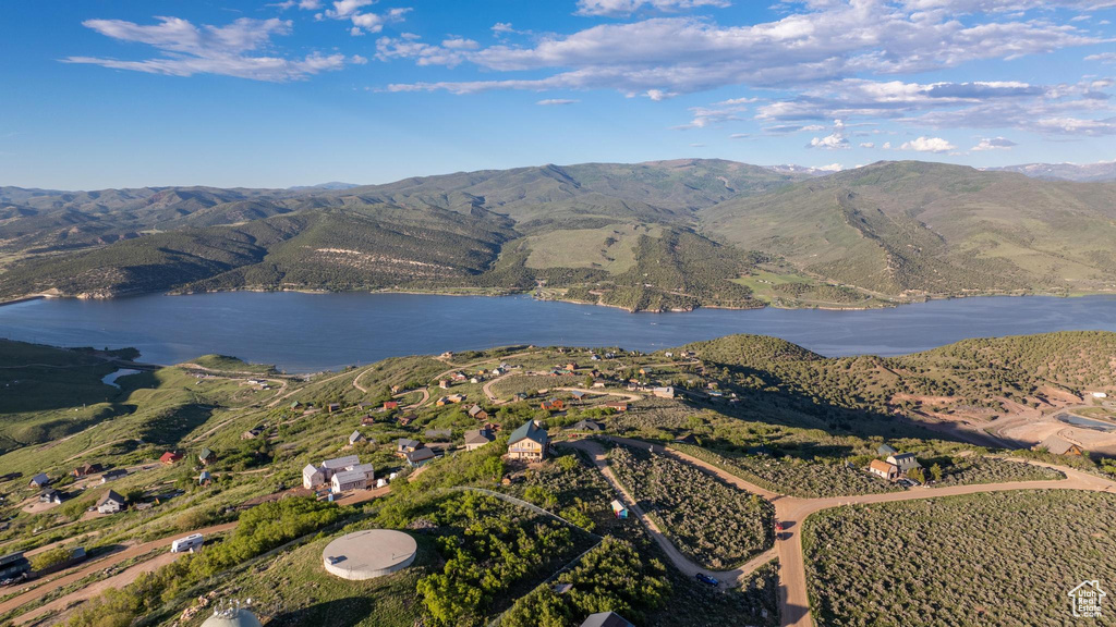 Birds eye view of property featuring a water and mountain view