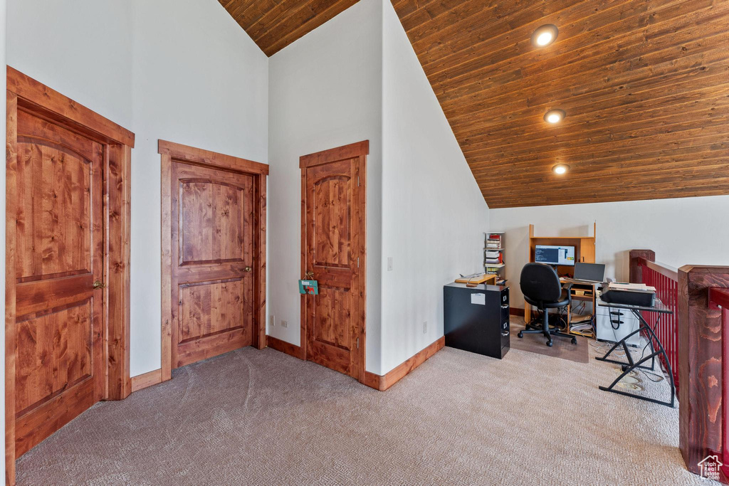 Office area featuring high vaulted ceiling, wood ceiling, and light carpet