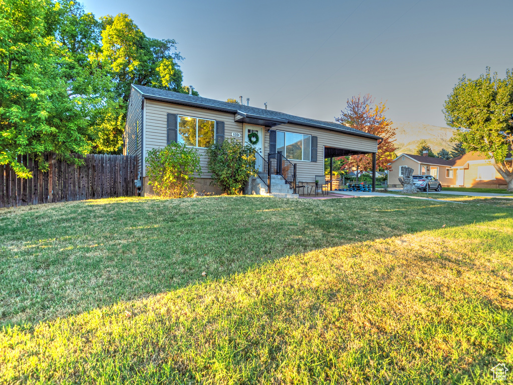 View of front of home featuring a patio and a front lawn