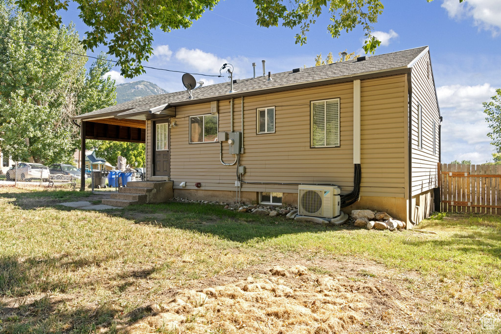 Rear view of house with a yard