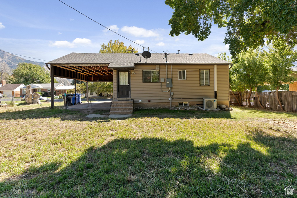 Rear view of house featuring a yard