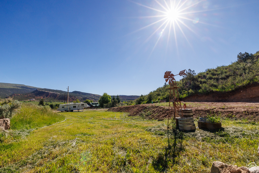 View of yard featuring a rural view and a mountain view