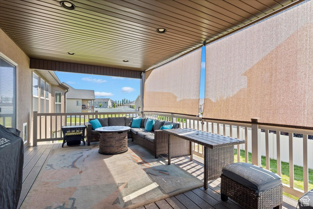 Wooden terrace featuring an outdoor living space