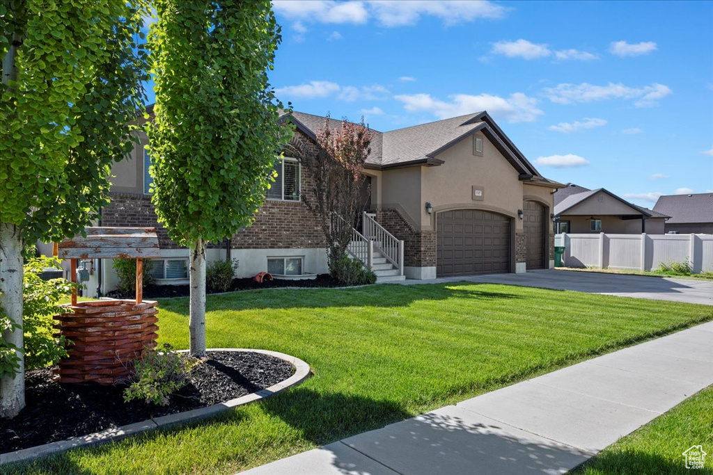 View of front of home featuring a garage and a front lawn