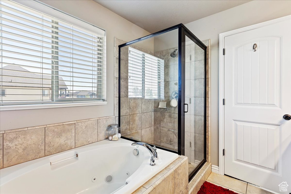 Bathroom featuring tile flooring and plus walk in shower