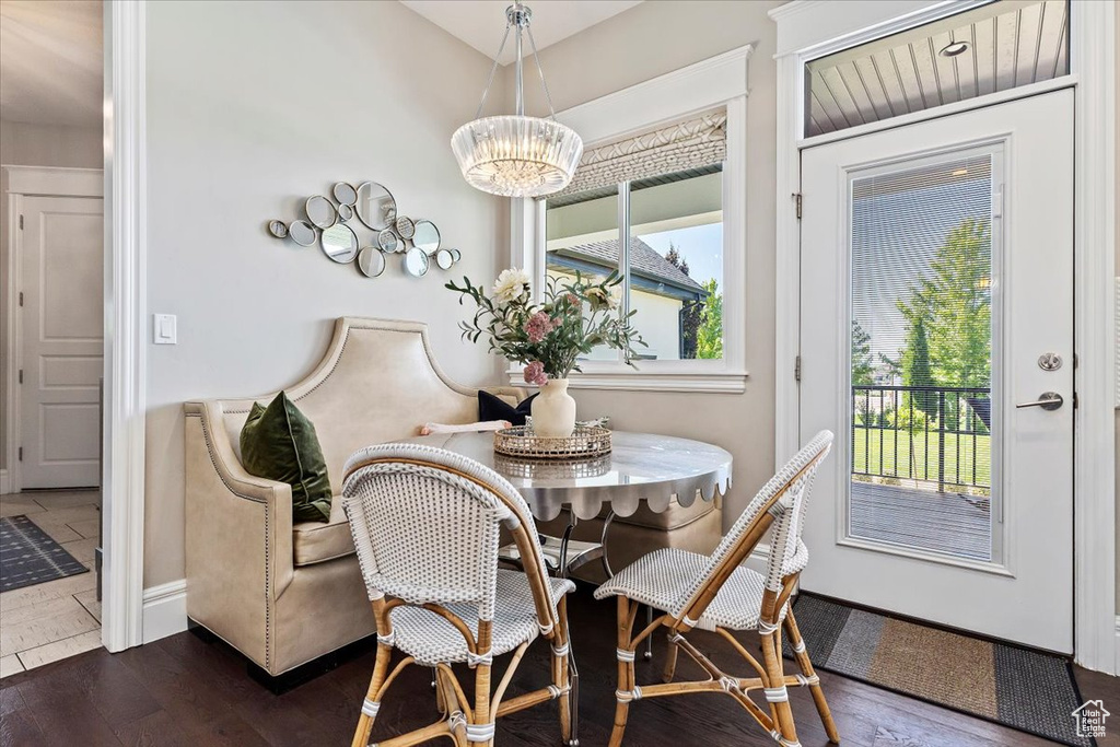 Dining space featuring a notable chandelier and dark hardwood / wood-style floors