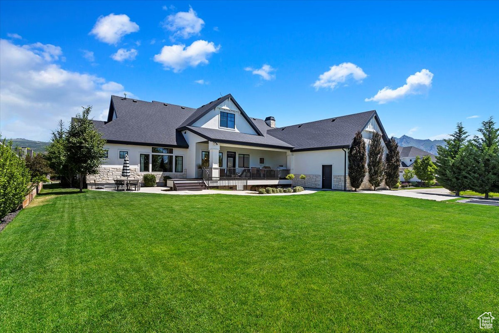 Rear view of house featuring a lawn