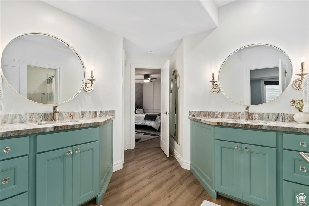 Bathroom featuring ceiling fan, hardwood / wood-style floors, and vanity