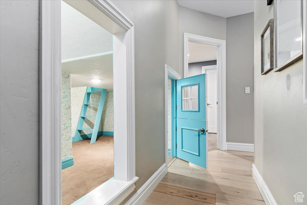 Hall featuring light colored carpet