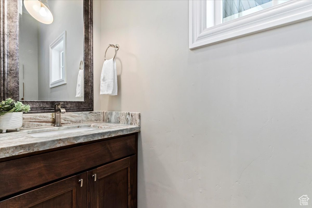 Bathroom with a wealth of natural light and vanity with extensive cabinet space