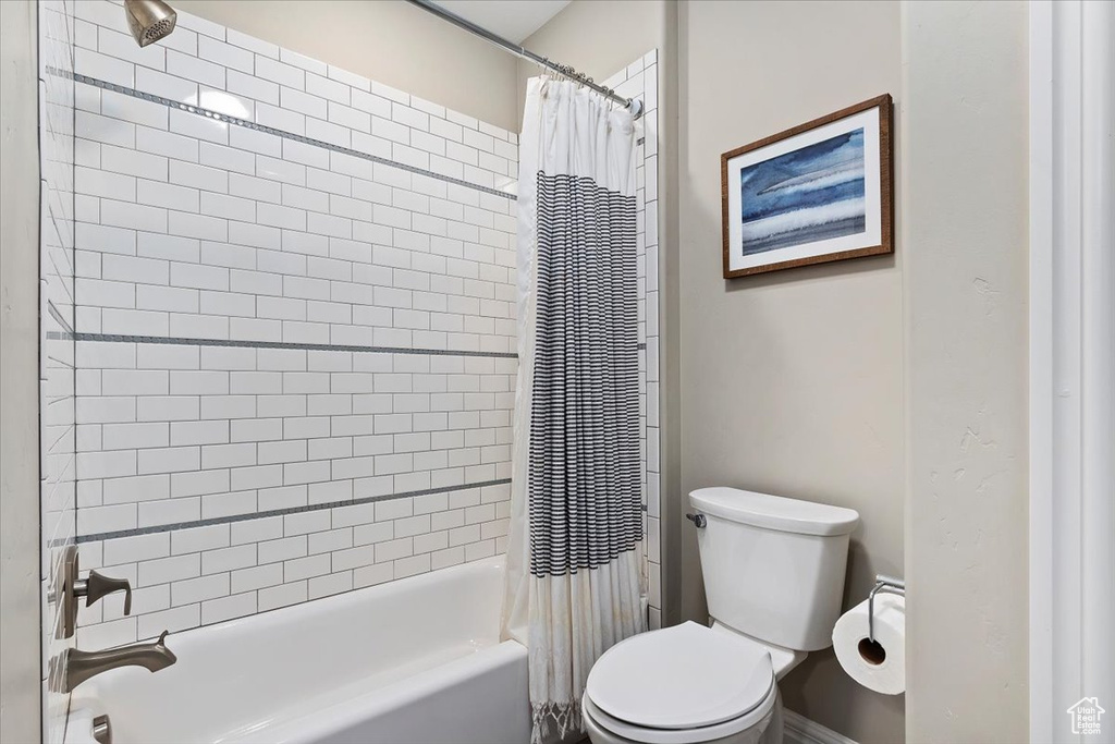 Bathroom featuring shower / bath combo and toilet