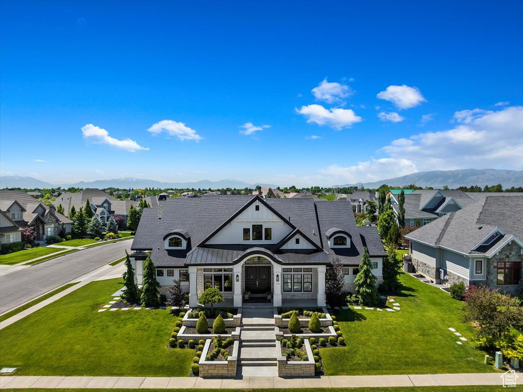 French country inspired facade featuring a front lawn and a mountain view