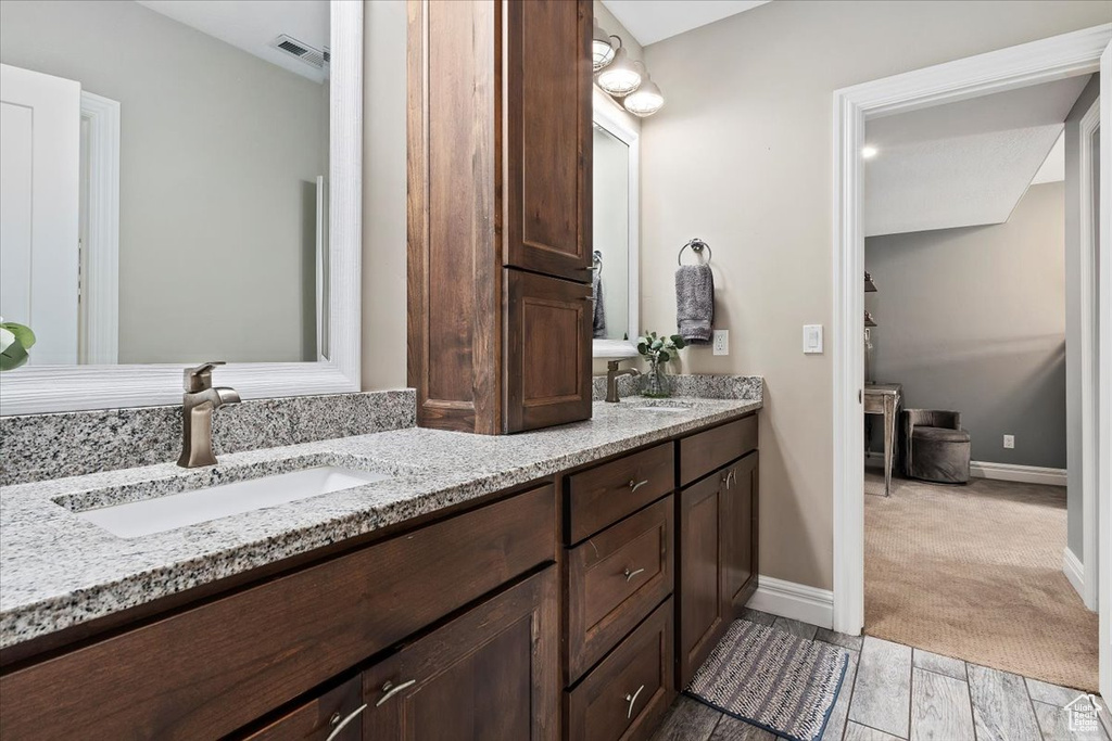 Bathroom featuring tile flooring and double sink vanity