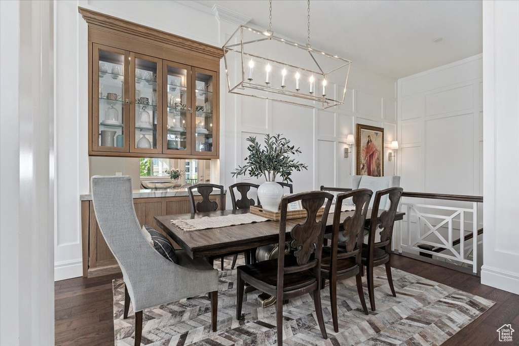 Dining room with dark hardwood / wood-style flooring