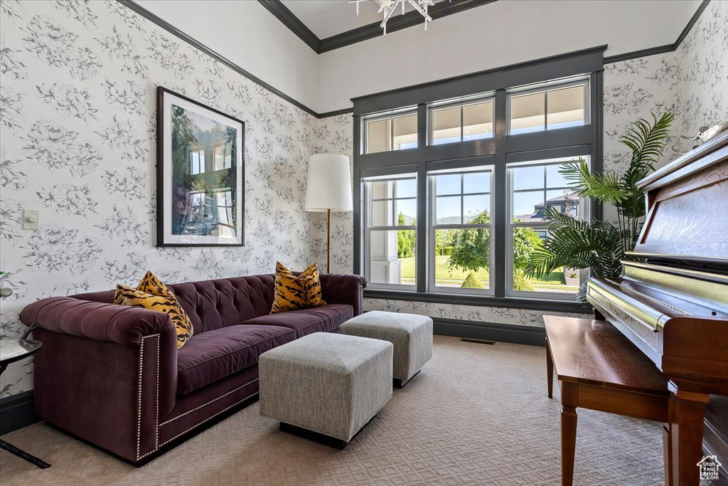 Living room with ornamental molding and carpet floors