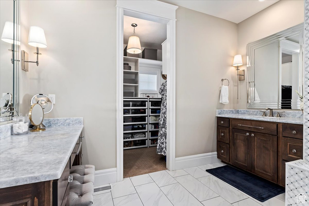 Bathroom featuring tile flooring and vanity