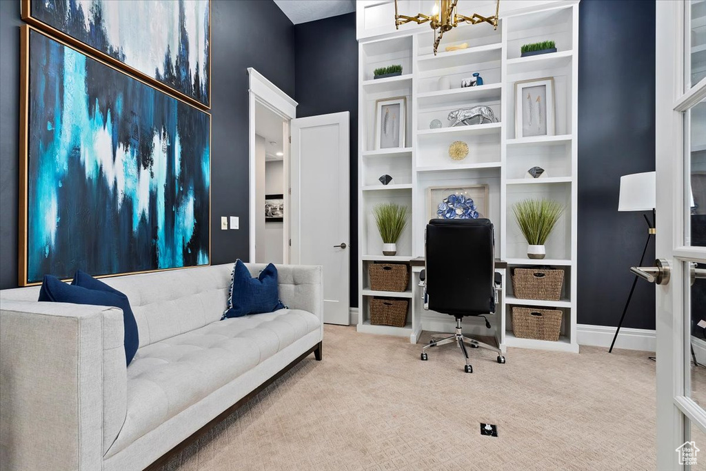 Carpeted office space with a chandelier