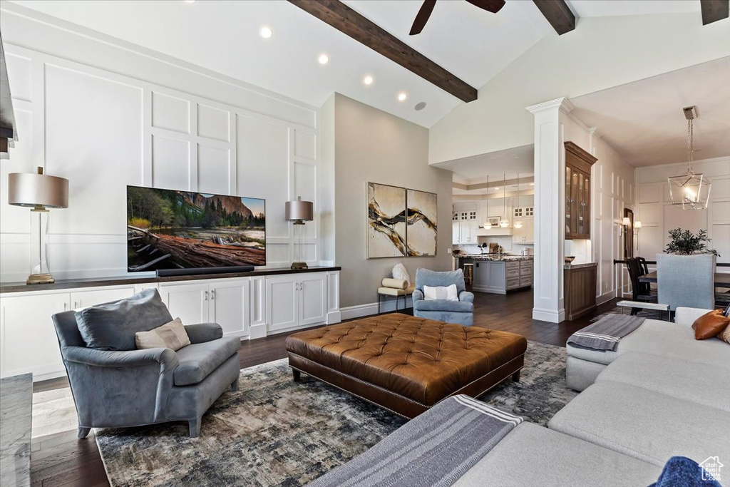 Living room featuring high vaulted ceiling, beam ceiling, ceiling fan, and dark hardwood / wood-style floors