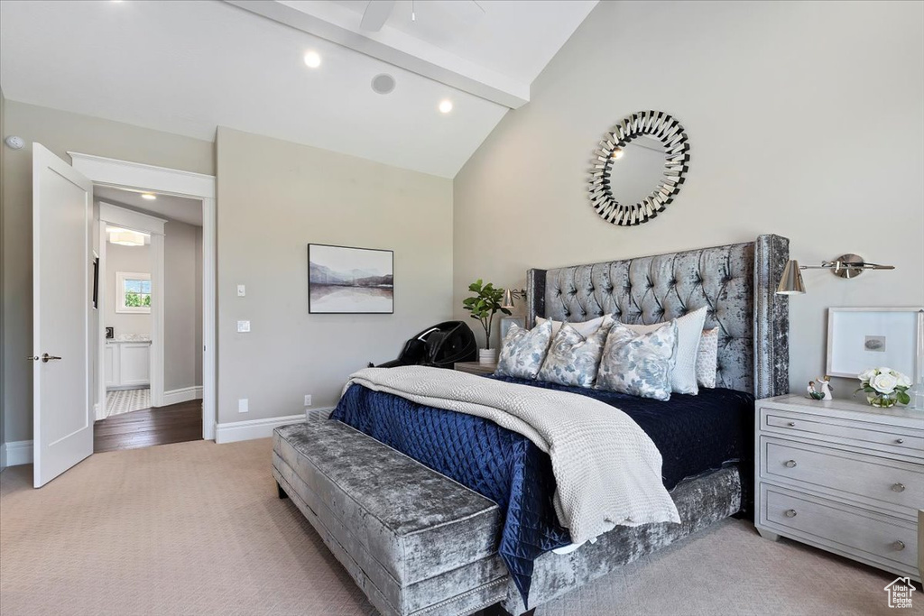 Bedroom with ceiling fan, carpet floors, beam ceiling, ensuite bath, and high vaulted ceiling