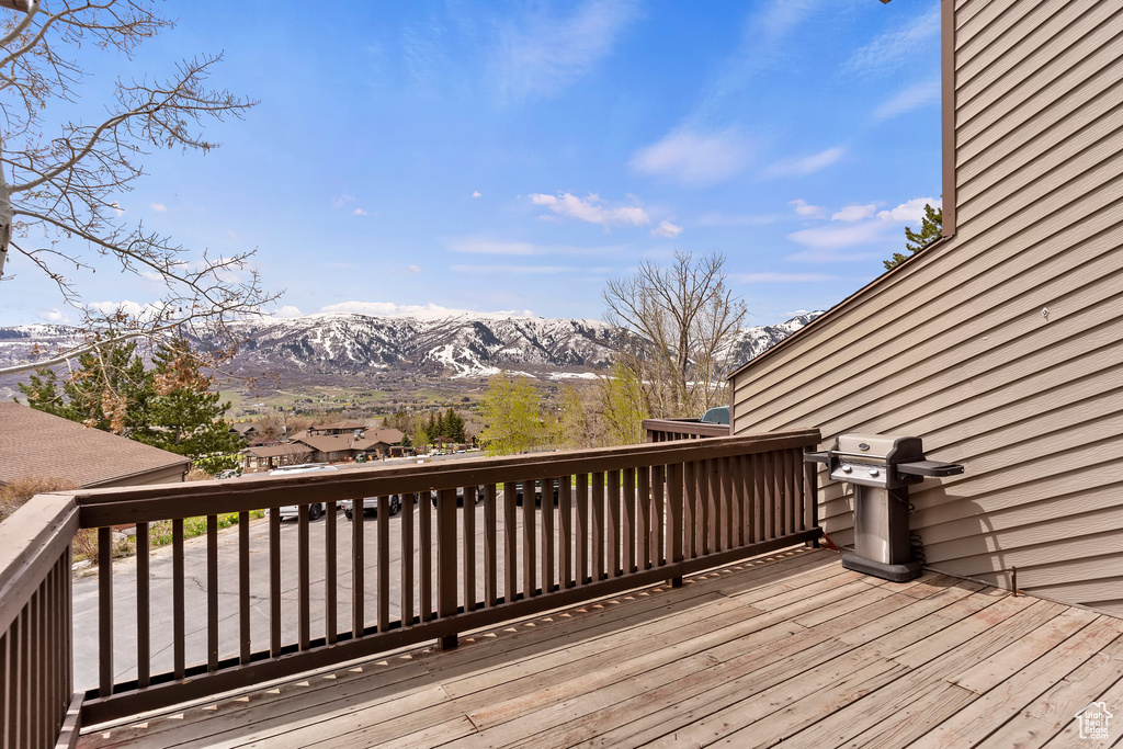 Wooden terrace featuring a mountain view