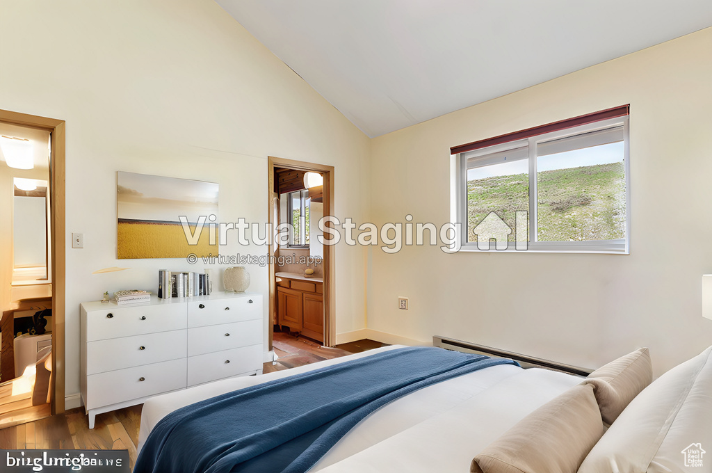 Bedroom with high vaulted ceiling, ensuite bathroom, light hardwood / wood-style floors, and a baseboard radiator