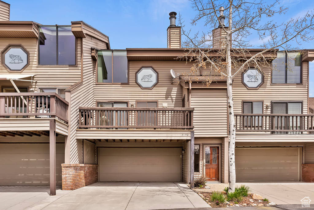 Multi unit property featuring a garage and a balcony