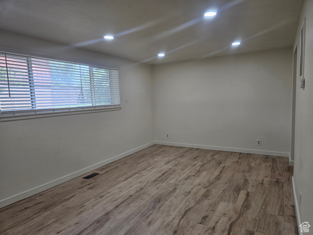 Empty room with hardwood / wood-style floors