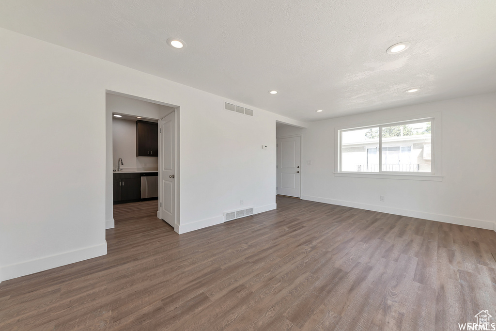 Empty room with sink and hardwood / wood-style flooring