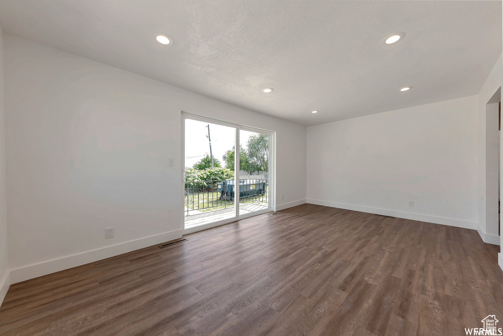 Unfurnished room with dark hardwood / wood-style floors