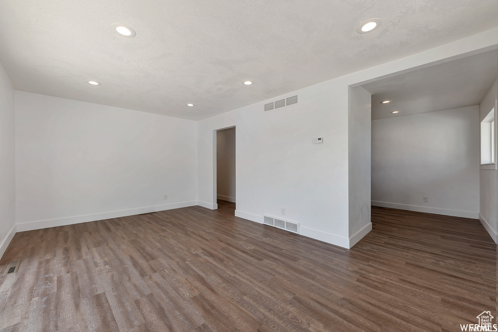 Spare room with dark hardwood / wood-style floors