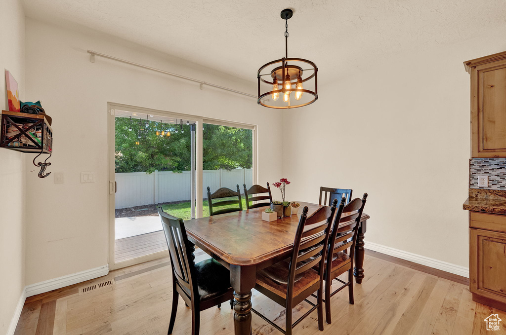 Dining room featuring light hardwood / wood-style floors and a chandelier