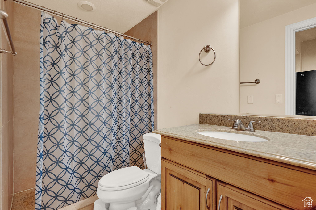 Bathroom featuring toilet and large vanity