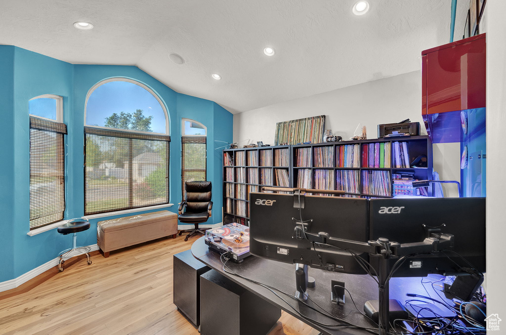 Office featuring wood-type flooring and vaulted ceiling