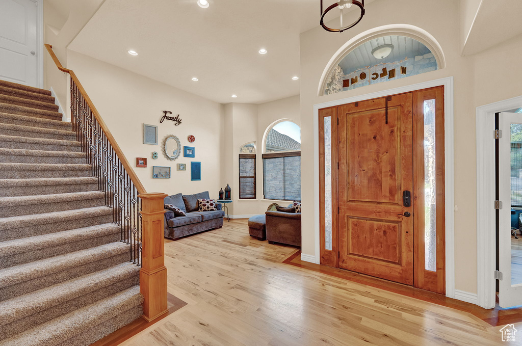 Entryway featuring a high ceiling and light wood-type flooring