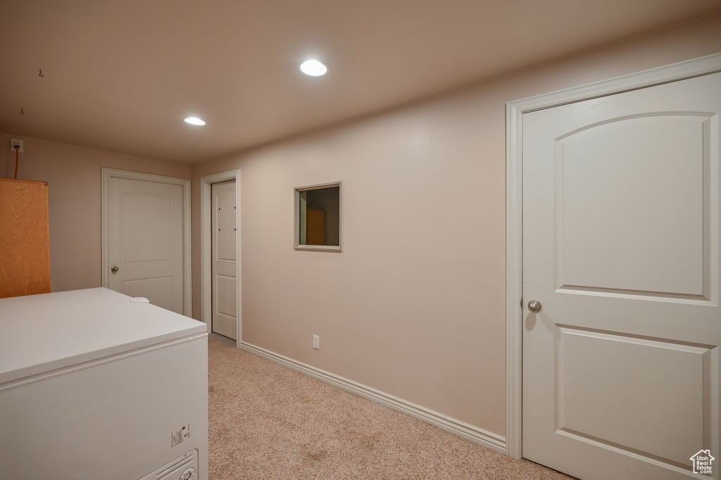 Washroom featuring light colored carpet