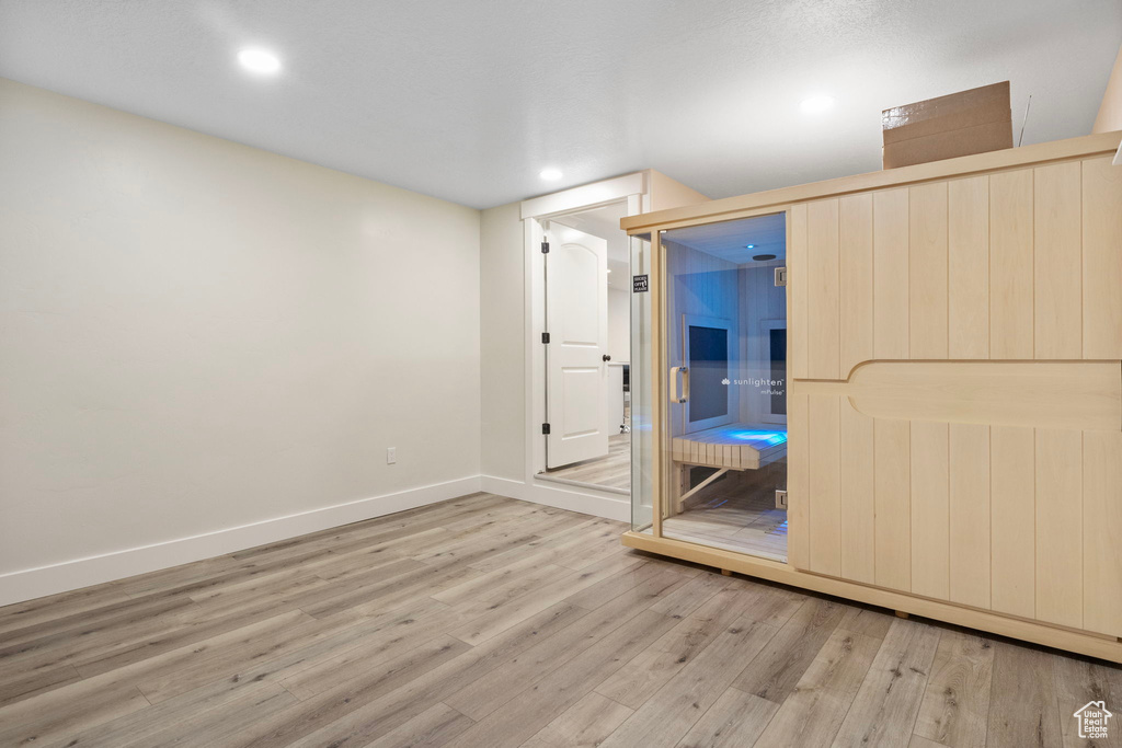 Empty room with light hardwood / wood-style floors