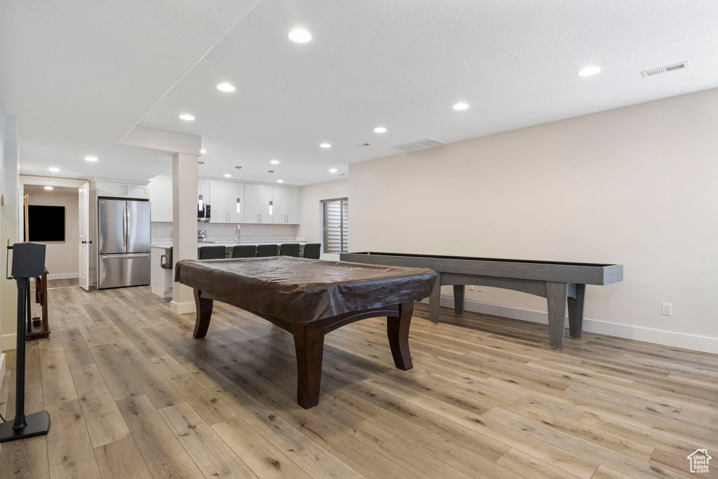 Recreation room with sink, billiards, and light wood-type flooring