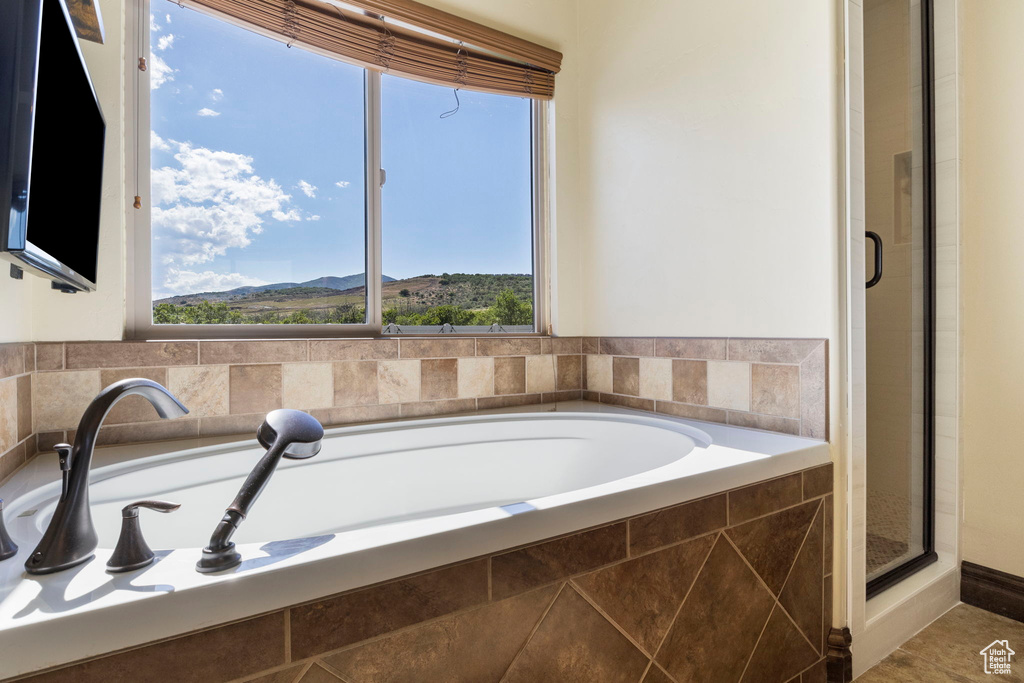 Bathroom with tile floors and shower with separate bathtub