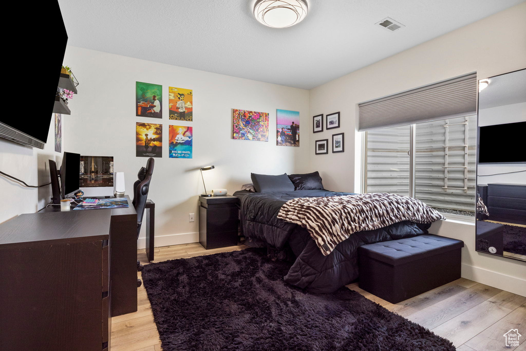 Bedroom with light hardwood / wood-style floors