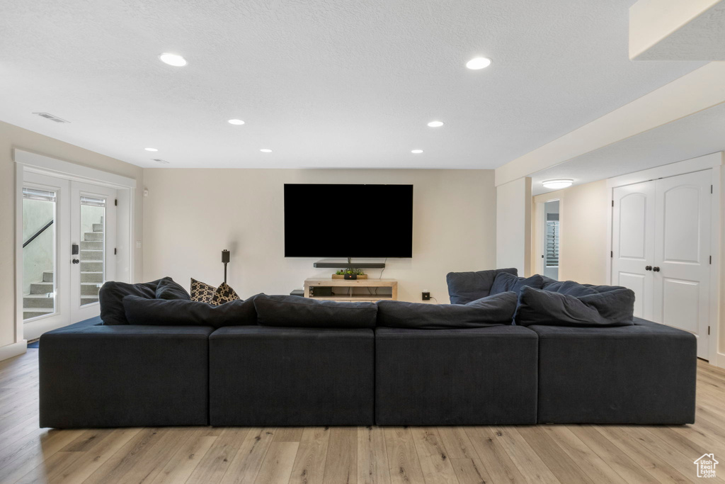 Living room featuring french doors and light wood-type flooring