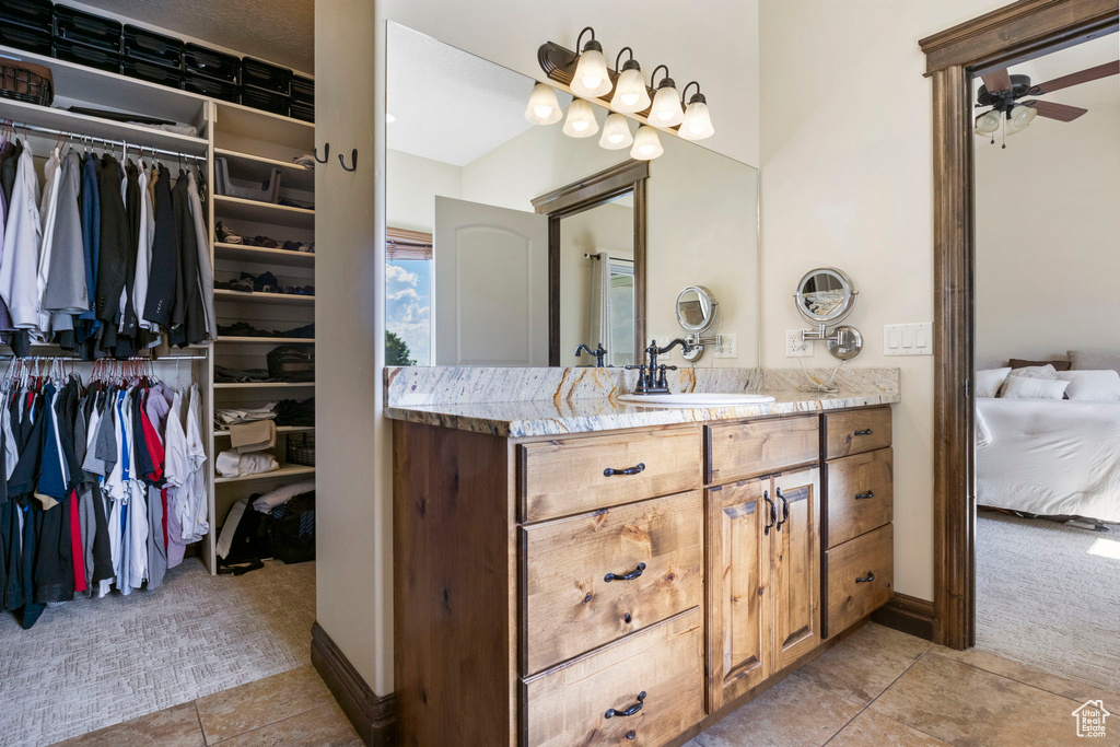 Bathroom with vanity, ceiling fan, and tile floors