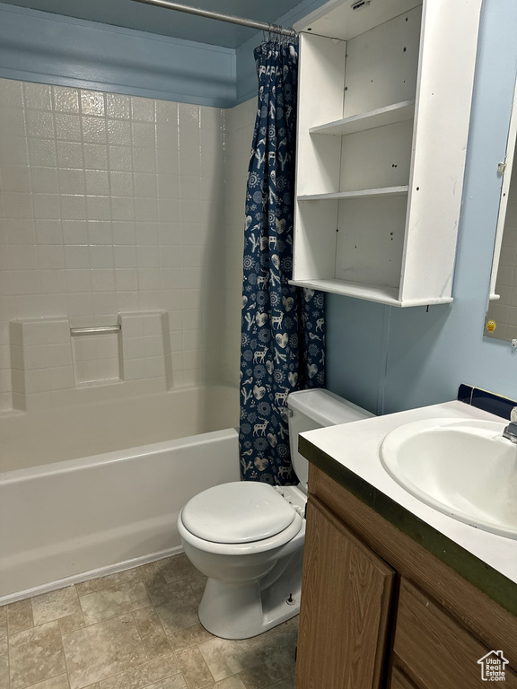 Full bathroom featuring tile flooring, shower / bath combo, toilet, and vanity