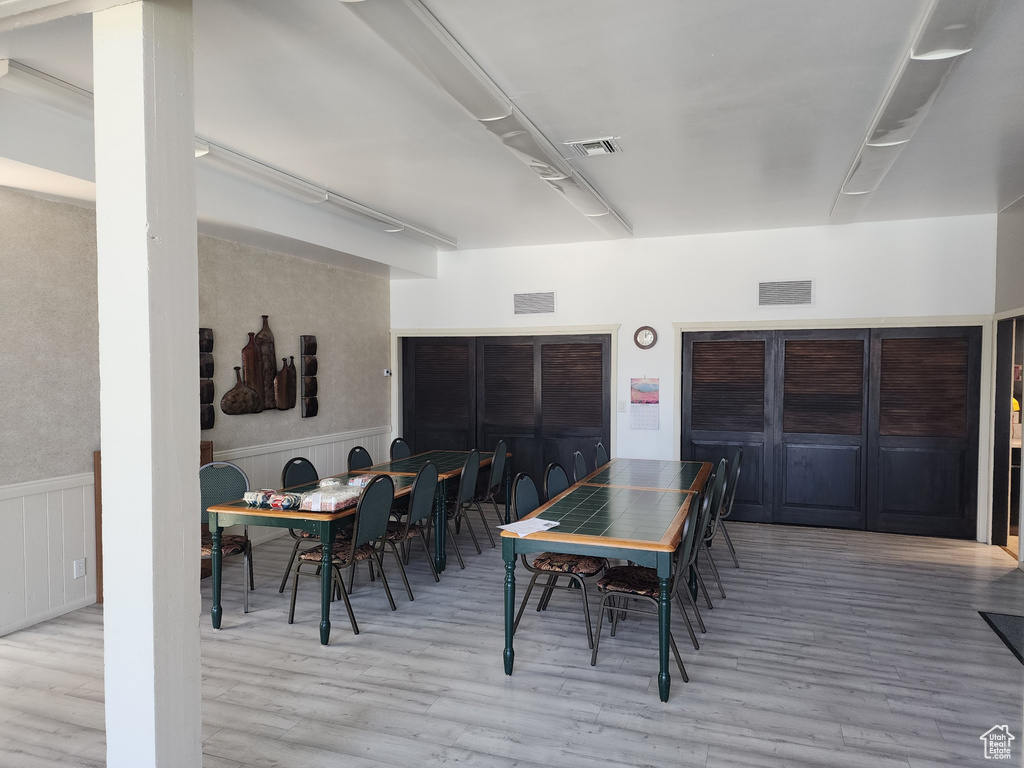 Dining space with hardwood / wood-style floors