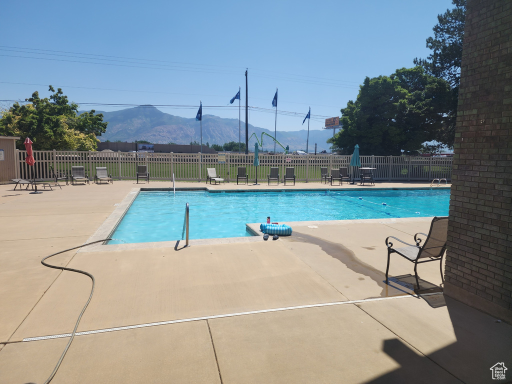 View of swimming pool with a patio area and a mountain view