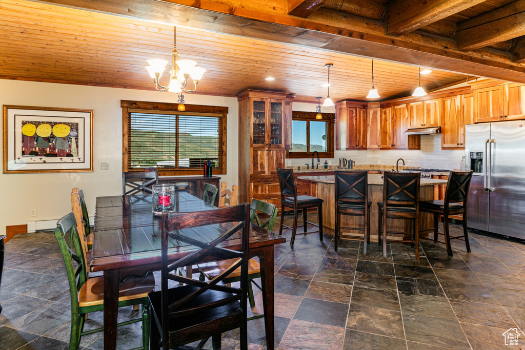 Tiled dining room featuring a chandelier, sink, a baseboard radiator, and wood ceiling