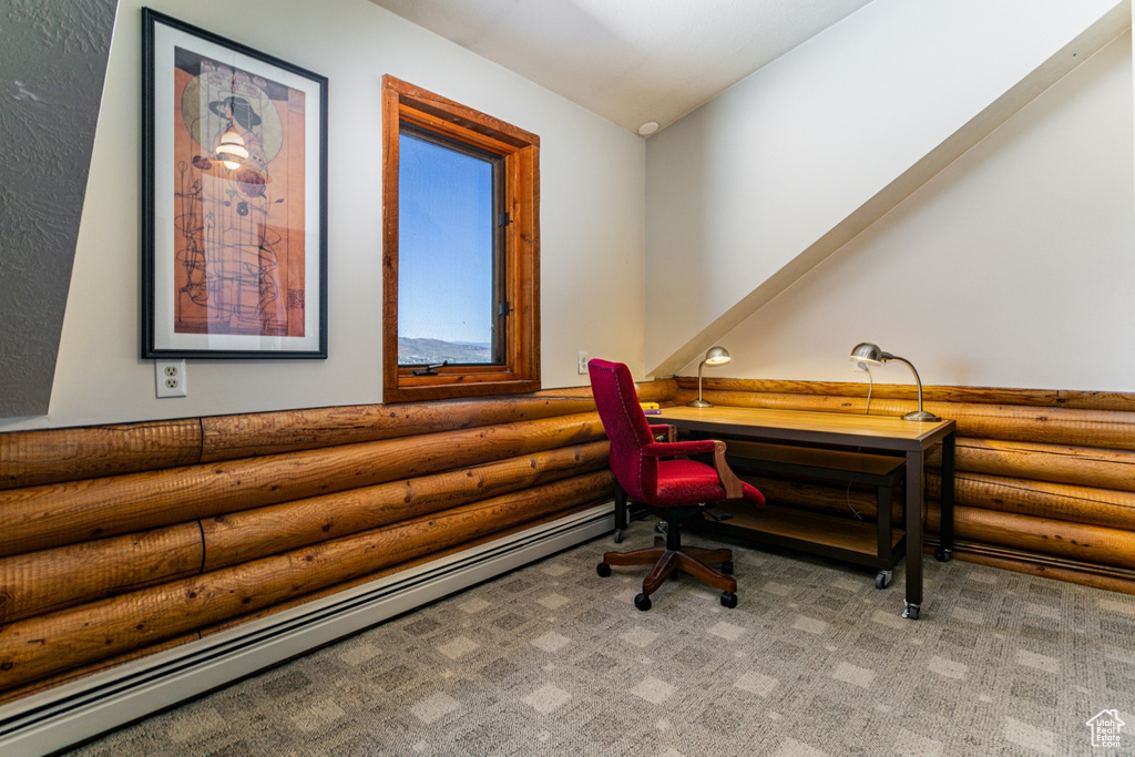 Carpeted home office featuring baseboard heating