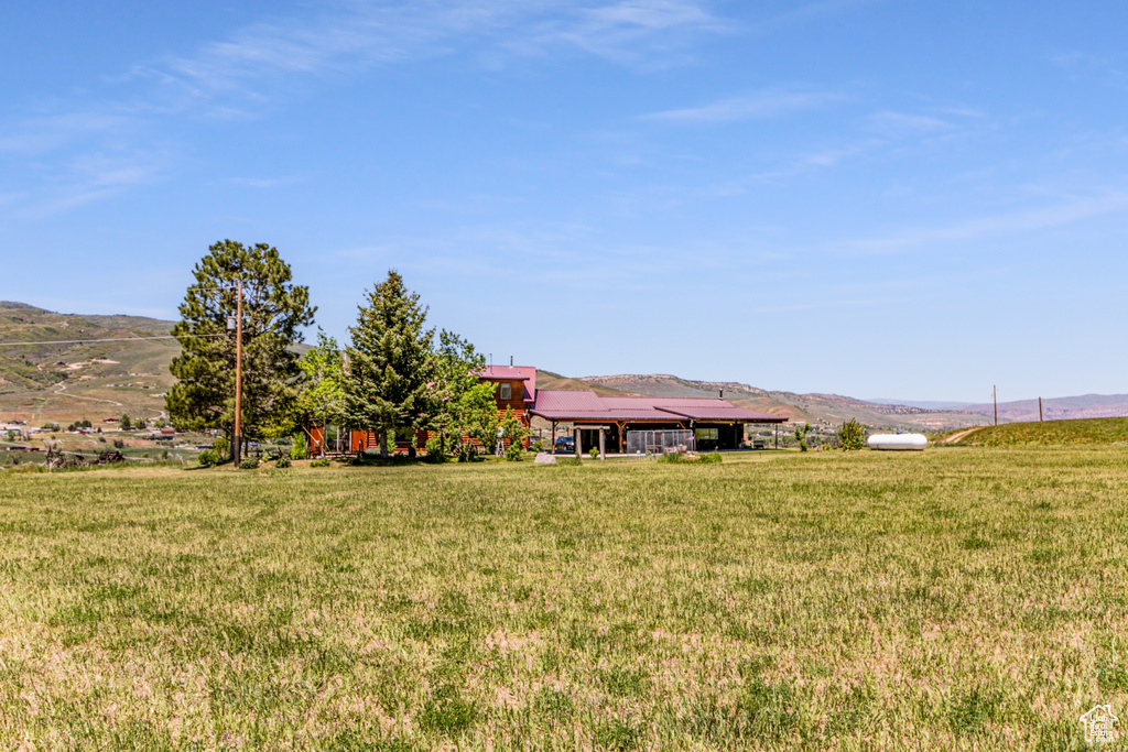 View of yard with a mountain view and a rural view