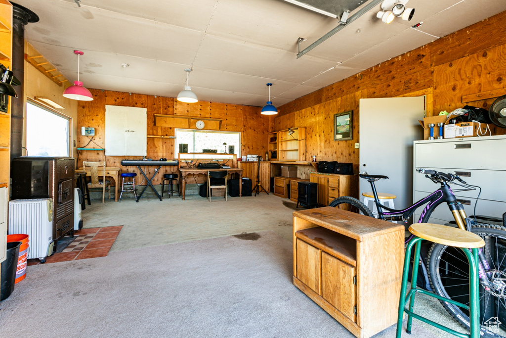 Garage with a workshop area and wood walls