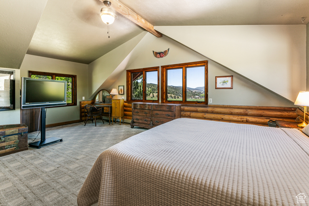 Carpeted bedroom with vaulted ceiling with beams and ceiling fan